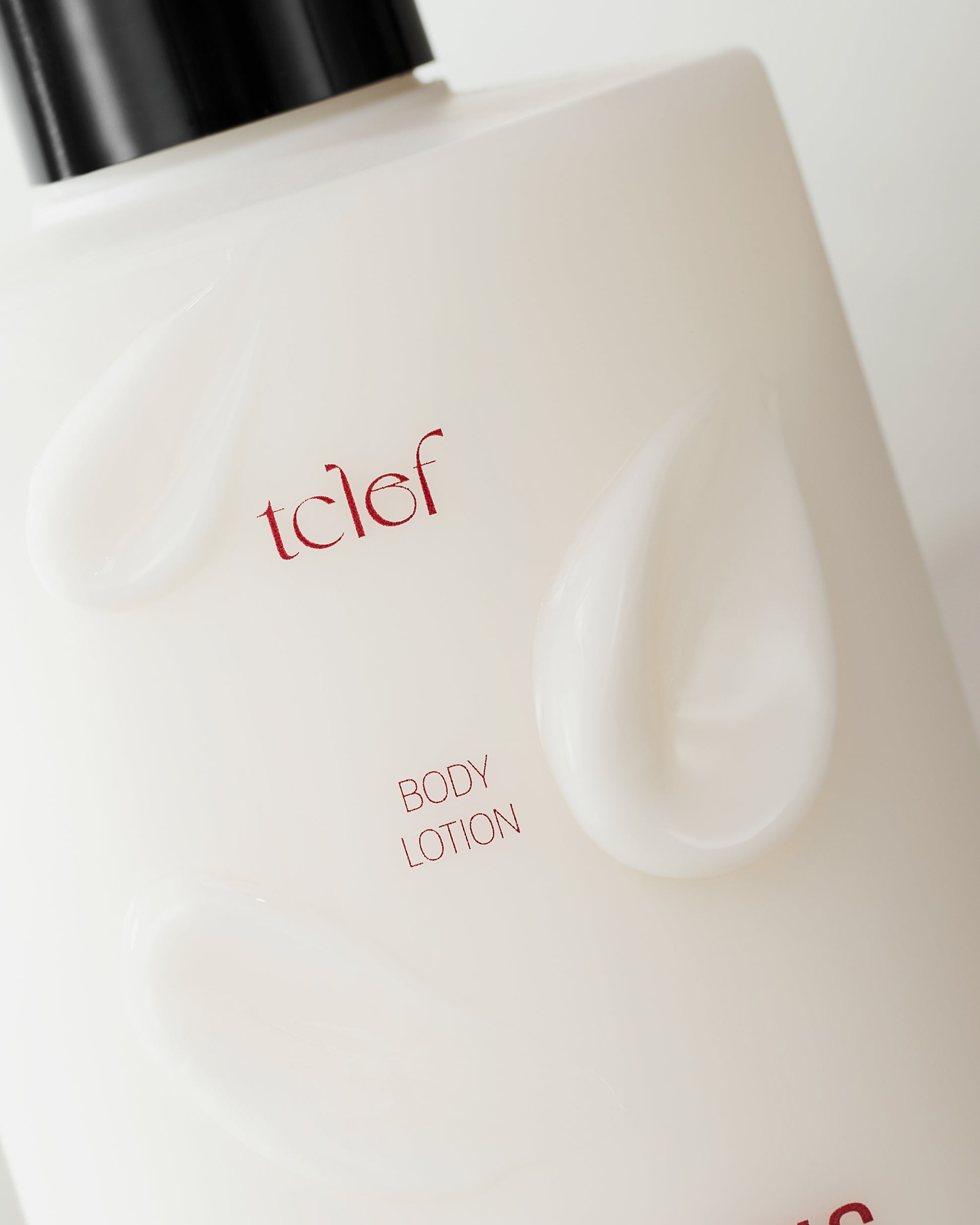 Elegant TCLEF Black Tea Body Lotion placed on a natural background with tea leaves, symbolizing deep hydration and vitality.