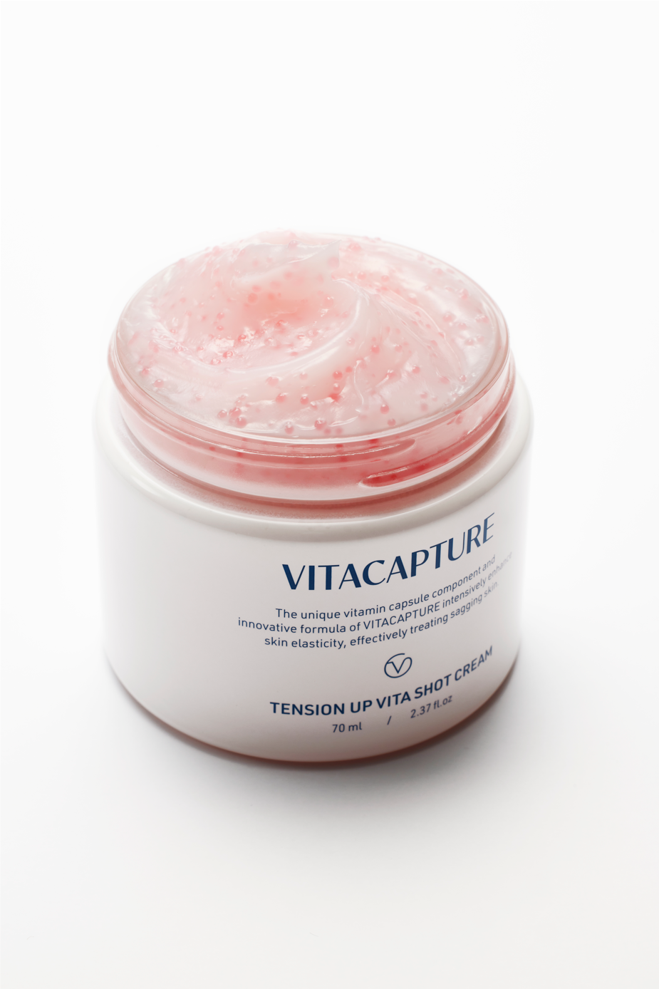 A person applying Tension Up Vita Shot Cream to their face, highlighting the visible effects of tightened, nourished, and moisturized skin, suggesting a glowing, healthier complexion.