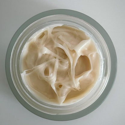 Mid Seaweed Rejuvenating Cream displayed on rustic slate with seaweed strands