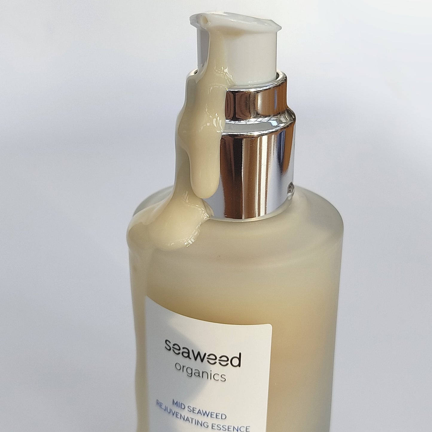 Rejuvenating sea essence set against weathered driftwood and coastal herbs