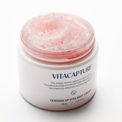 A person applying Tension Up Vita Shot Cream to their face, highlighting the visible effects of tightened, nourished, and moisturized skin, suggesting a glowing, healthier complexion.